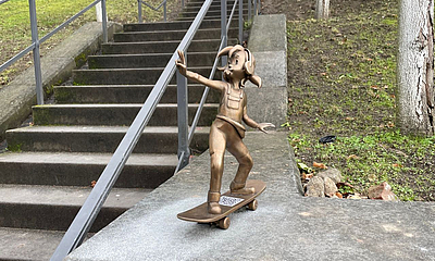 Jugend-Pine bronzene Pine-Figur skatet an den Schlosstreppen